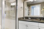Second en suite bathroom features granite countertops and shower. 